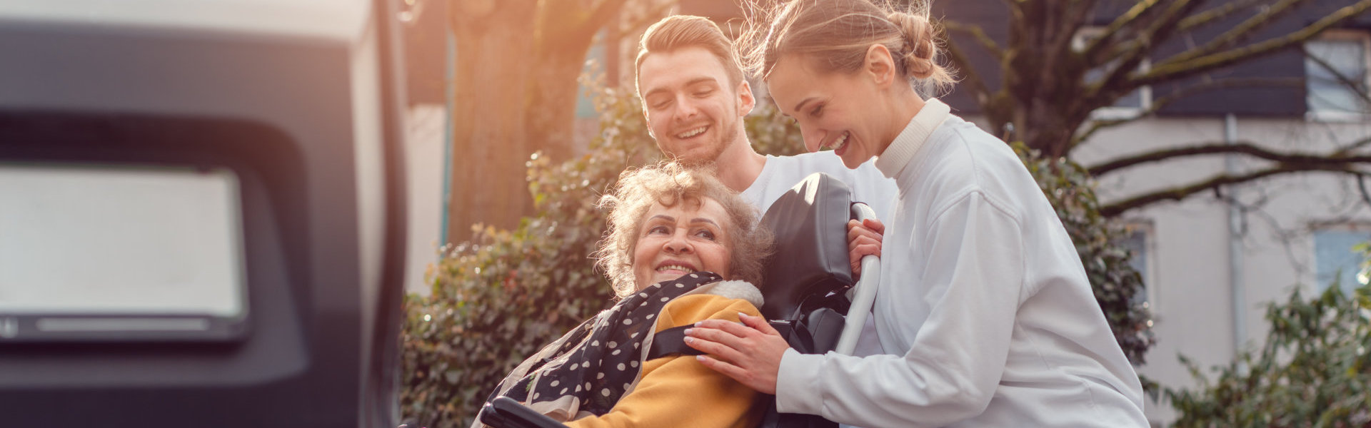 Man and Woman helping transport an elderly woman