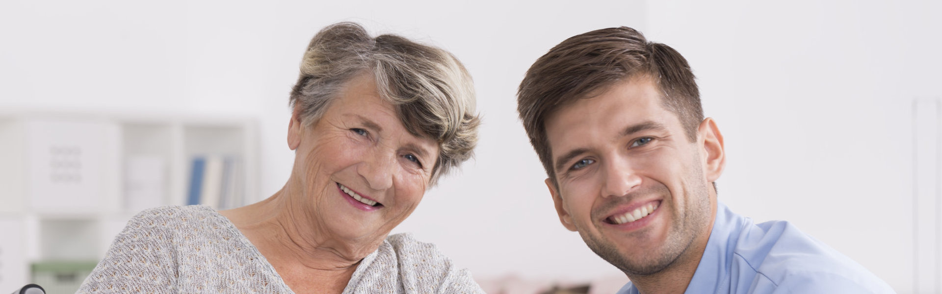 Happy elderly women with male caregiver in retirement home